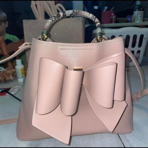 Light pink cute like dreams vegan  leather purse with faux snake skin handle.